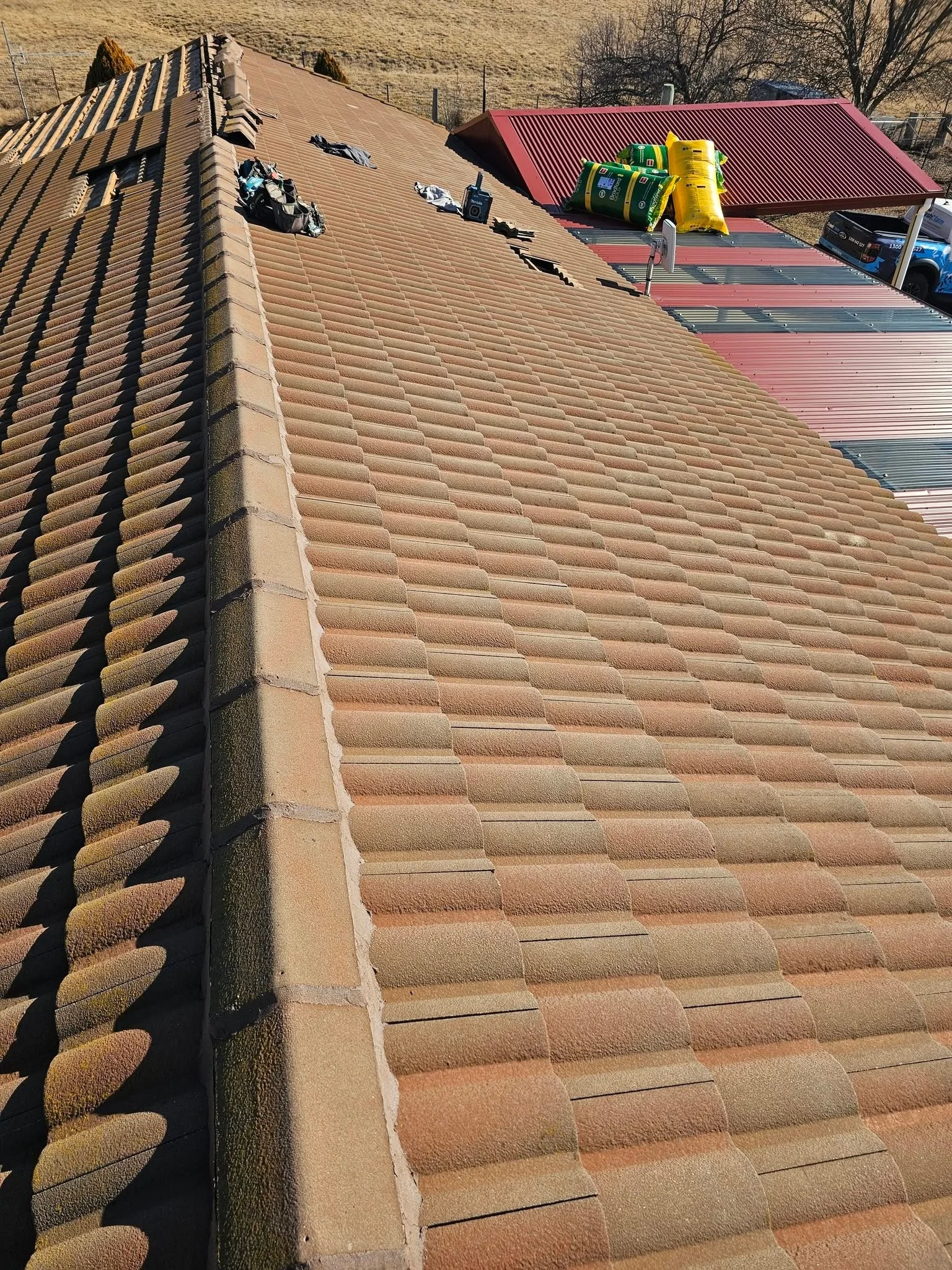 Close-up of properly integrated step flashing repair at a roof-to-wall transition in Ocala FL